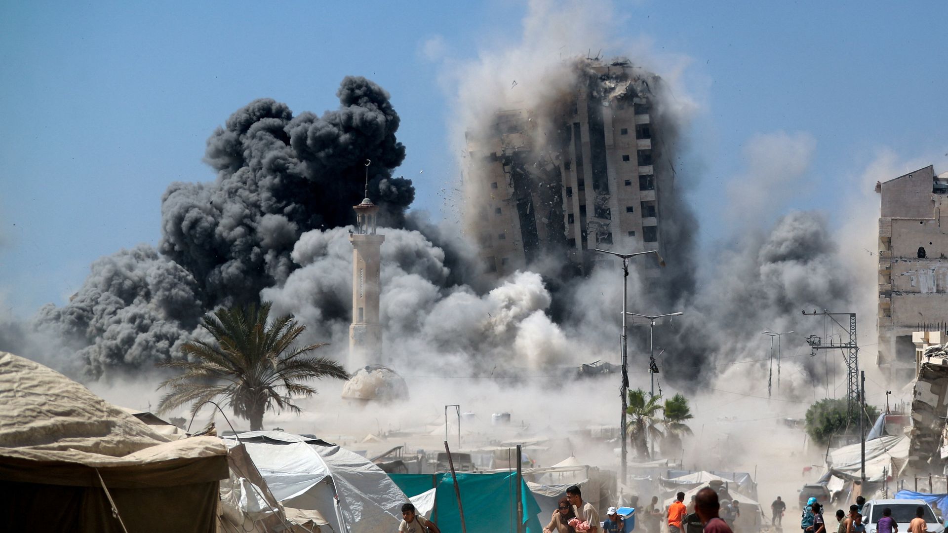 Two hostages shown in Hamas video - as Israel strikes high-rise building in Gaza City
