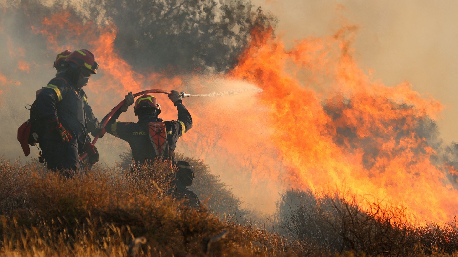 Hundreds on Greek island flee raging wildfire that officials warn 'they cannot stop'