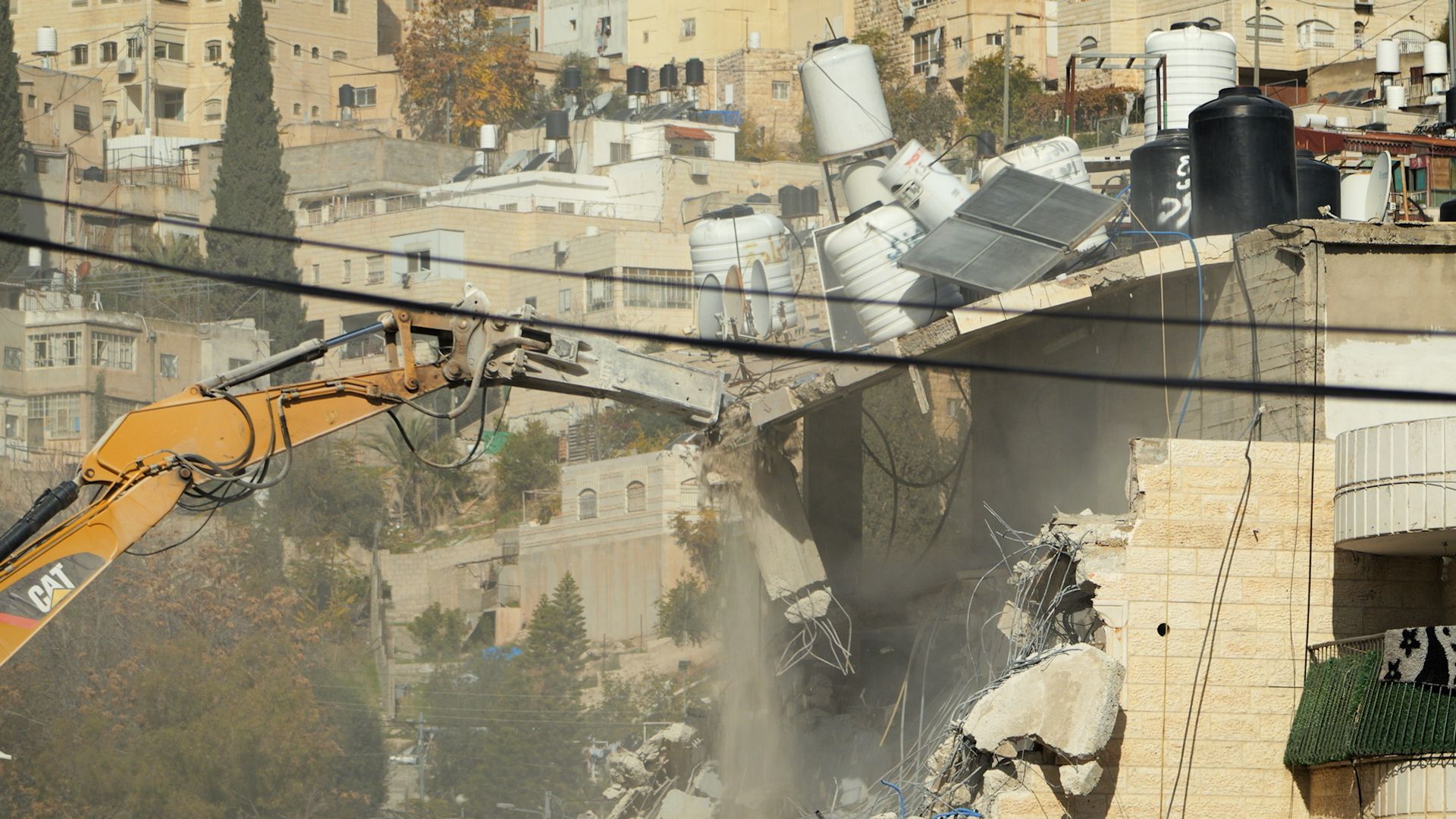 'No one is here to help us': Palestinians watch on as Israeli diggers tear down their homes in East Jerusalem