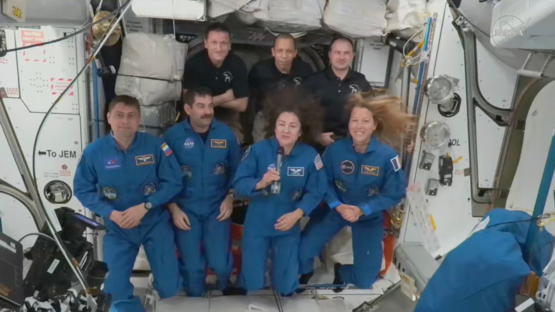 Astronauts hug and high-five as new crew arrive at International Space Station