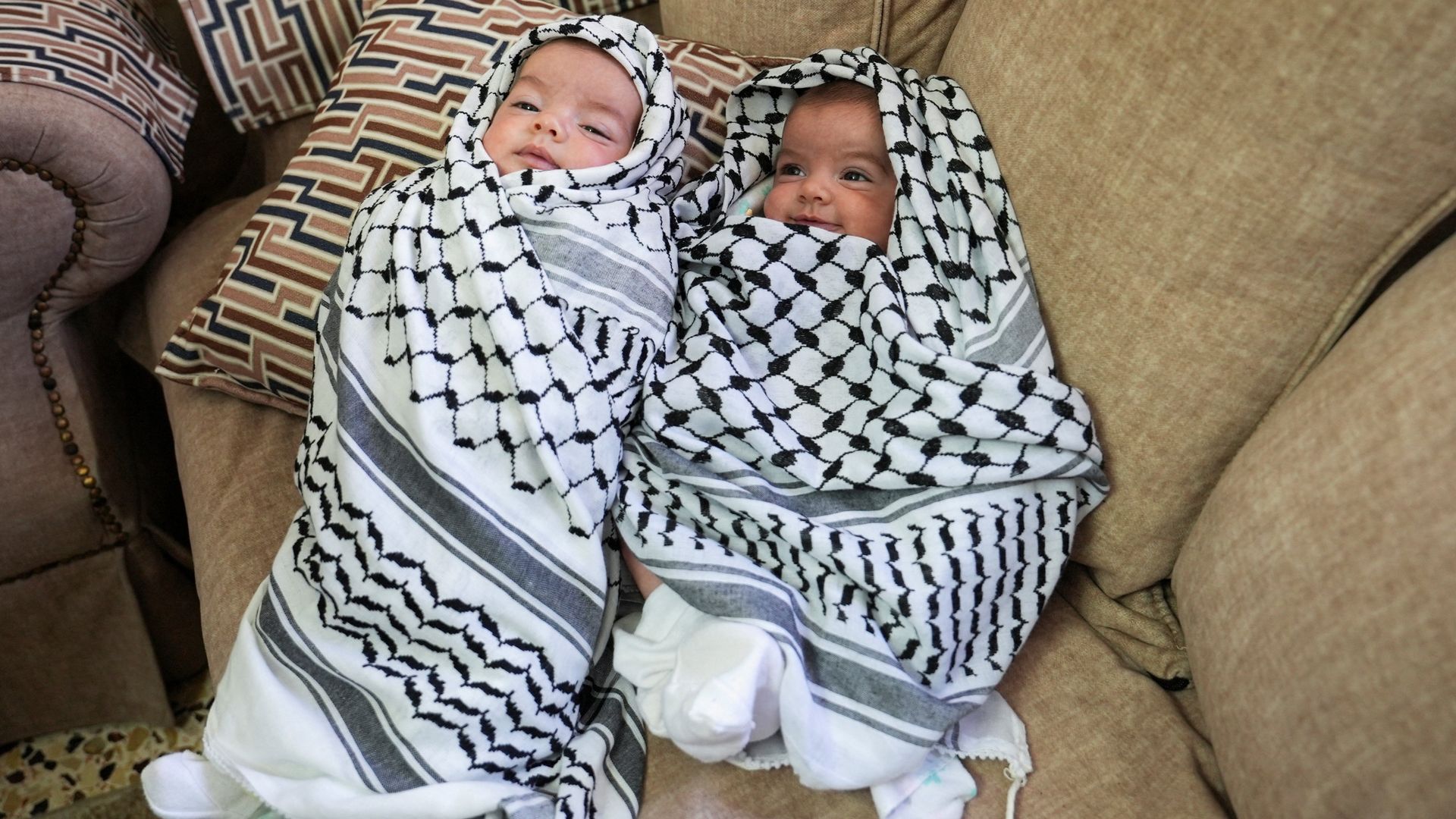 Baby girls held aloft at funeral of father shot during Israeli settler attack