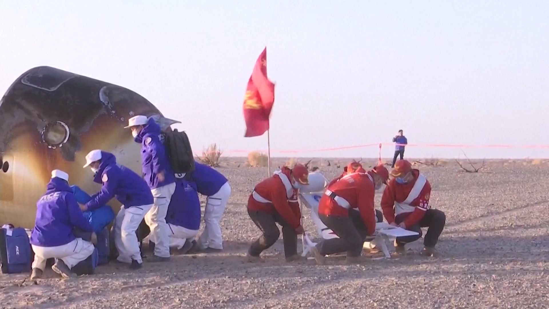 Stranded Chinese astronauts return to Earth after space capsule damaged