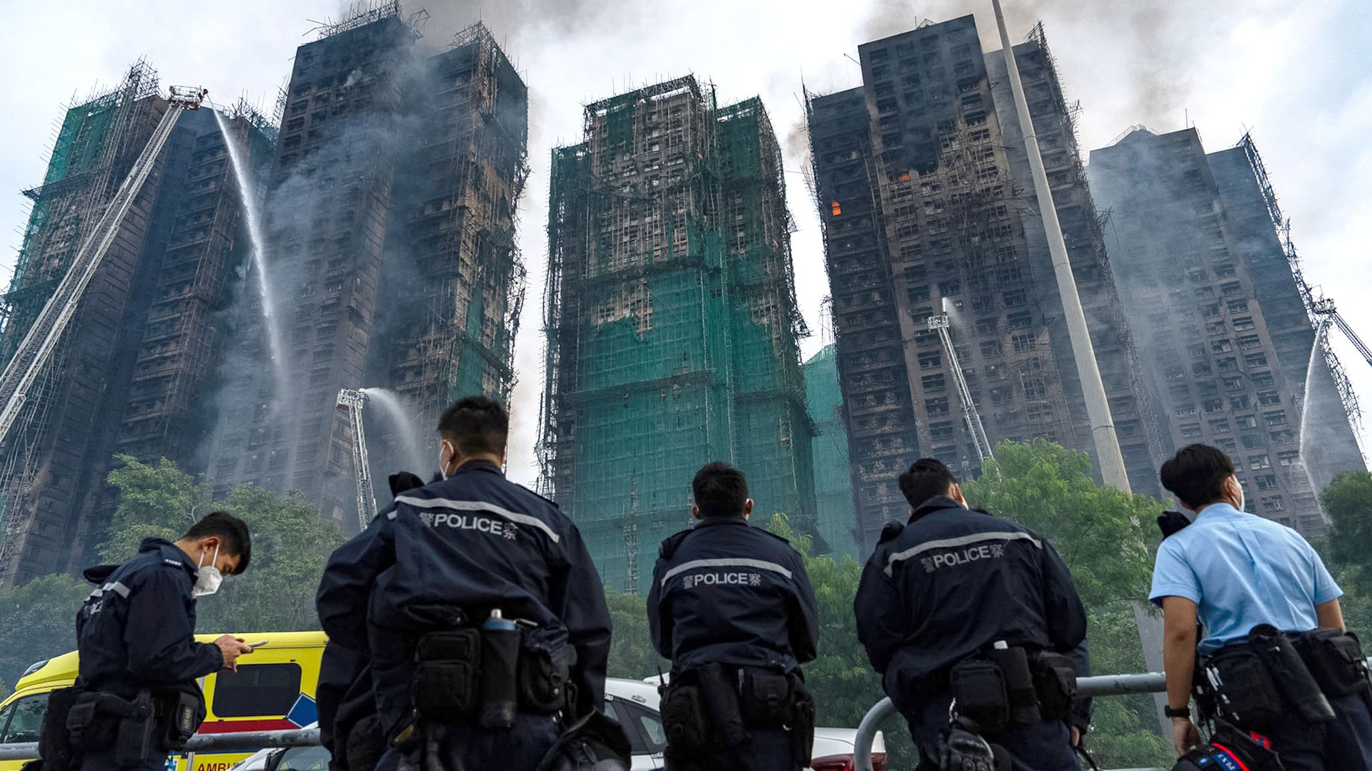 At least 65 dead and hundreds missing as police make arrests over Hong Kong fire