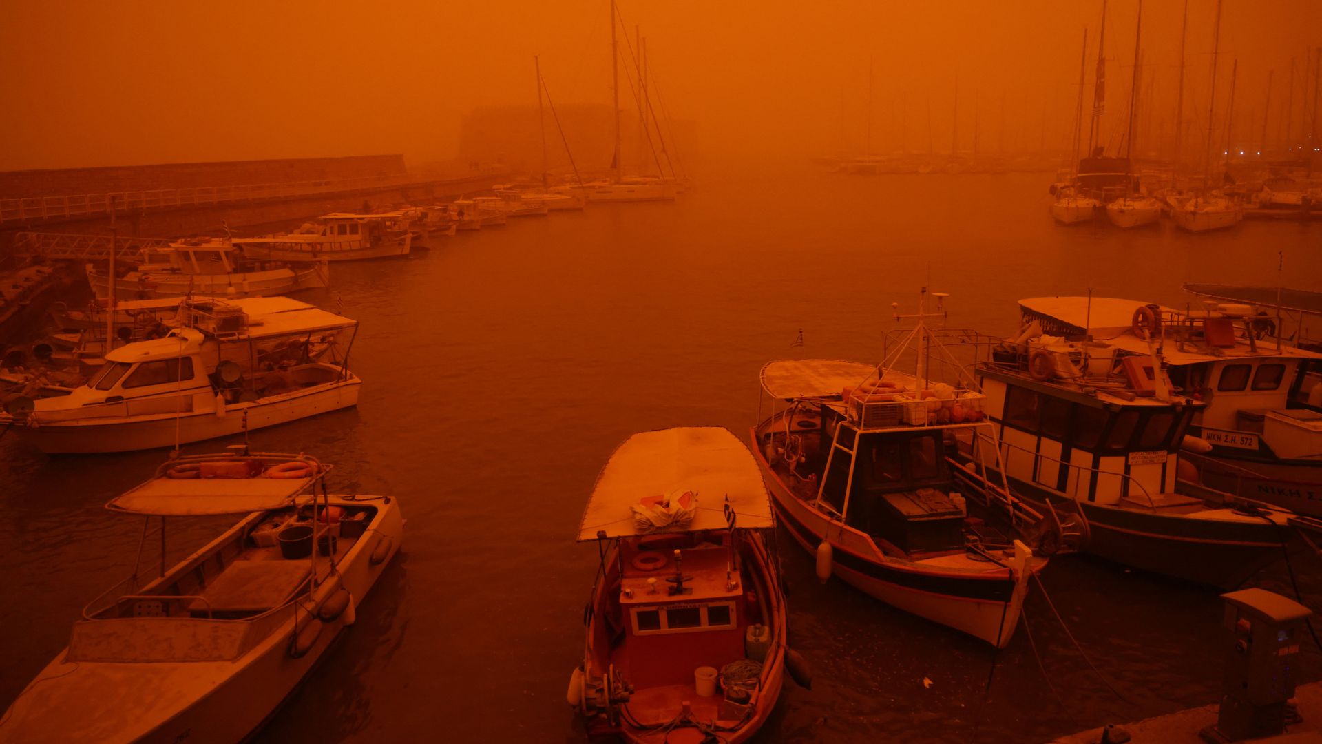 Holiday island is cloaked by Saharan dust storm - turning its blue skies blood red